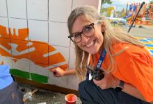  principal stillwell painting mural with big smile